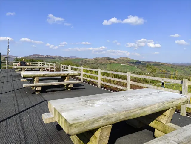 a deck with picnic tables