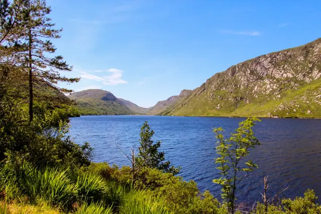 a body of water surrounded by hills