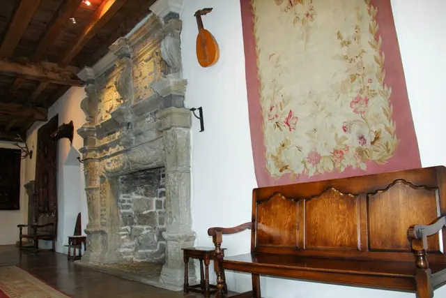 a room with a bench and a wall with a painting on it