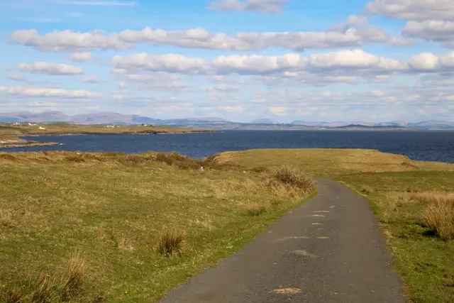 a road next to a body of water