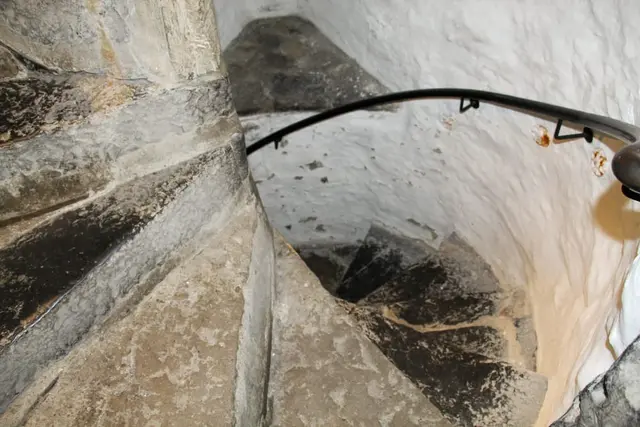 a stone wall with a stone arch