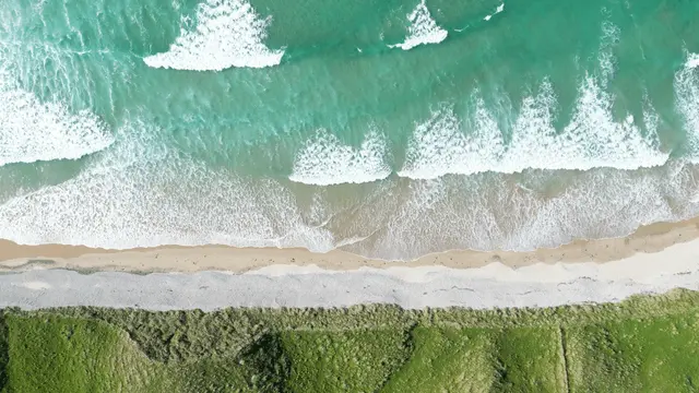 a wave crashing on a beach