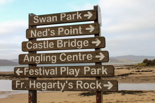 a sign board with arrows pointing in different directions