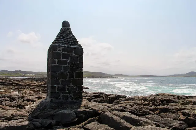 a stone tower on a rocky beach
