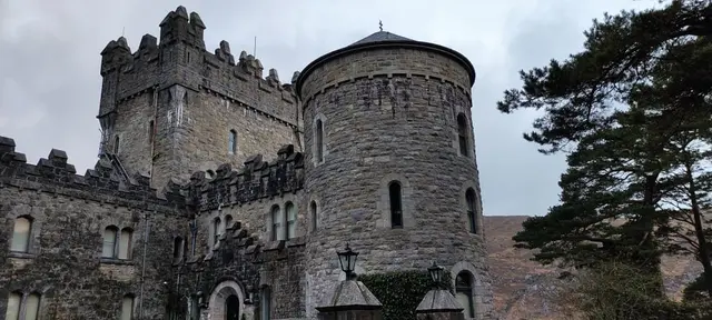 a stone building with a tree in front of it