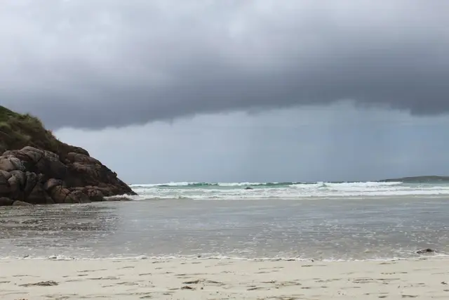 a beach with waves crashing on it
