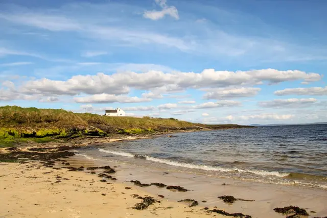 a beach with a house on it