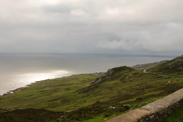a grassy hill overlooking a body of water