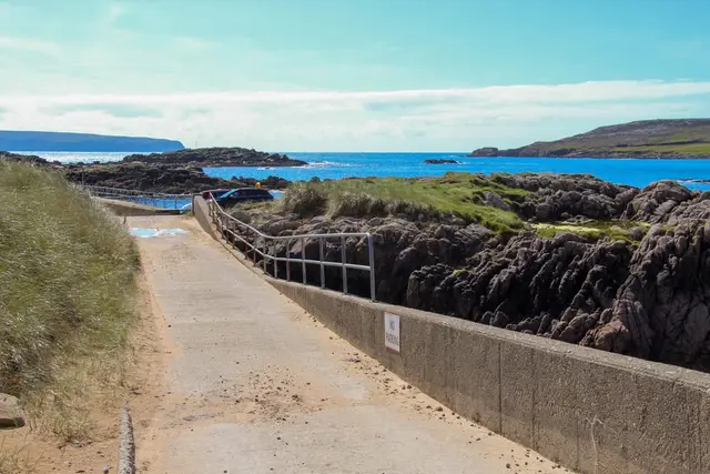 a road next to a body of water