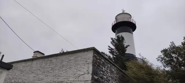 a white tower with a red and white top and a white top