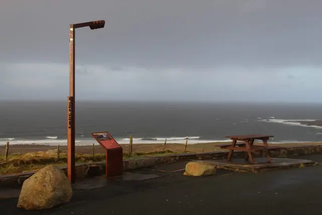 a bench sits on the side of a road