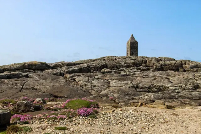 a stone tower on a rocky hill