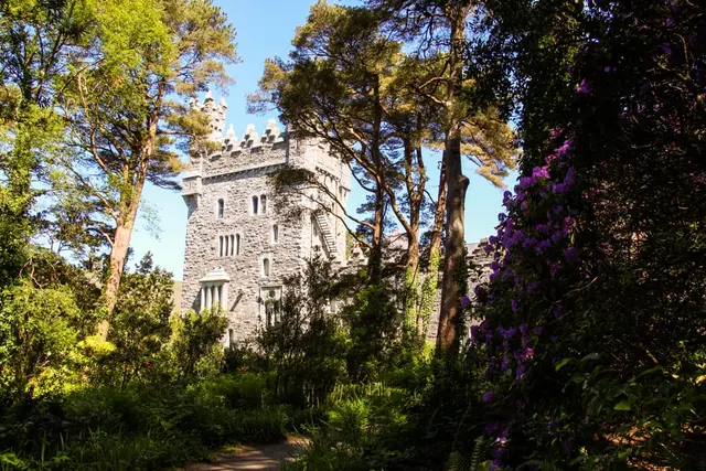 a stone building surrounded by trees