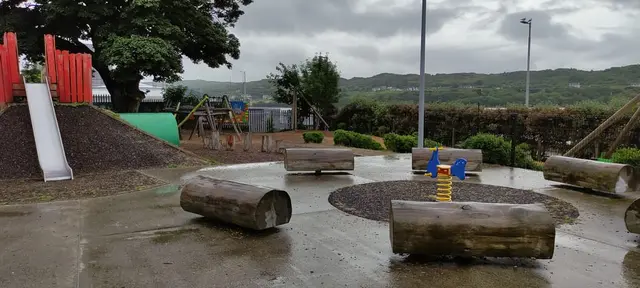 a playground with rocks and trees