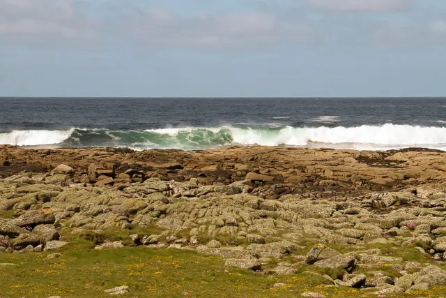 a rocky beach with waves crashing