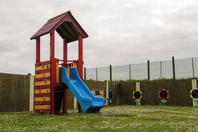 a play structure in a grassy area