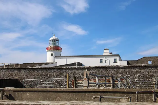 a white building with a red and white tower