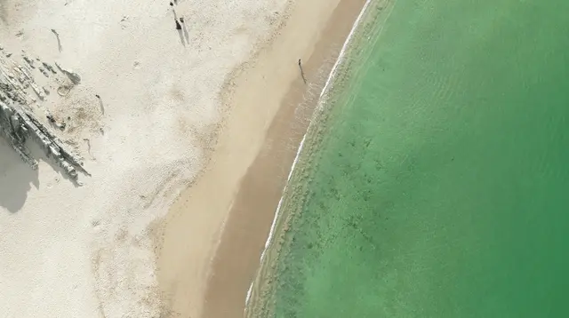 a beach with a body of water