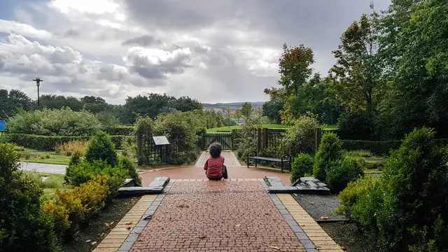 a person sitting on a brick walkway