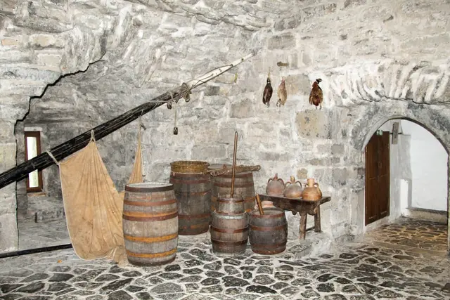 a group of barrels in a stone room