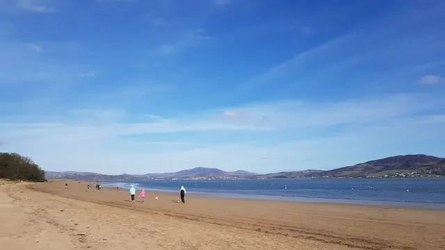 people walking on a beach