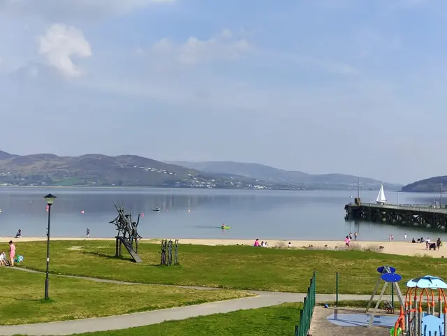 a beach with a pier and a body of water