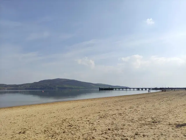 a beach with a pier and water