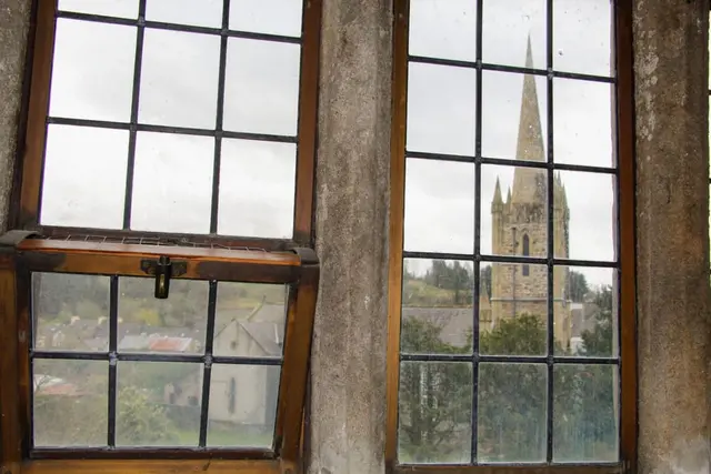 a window with a view of trees and a building