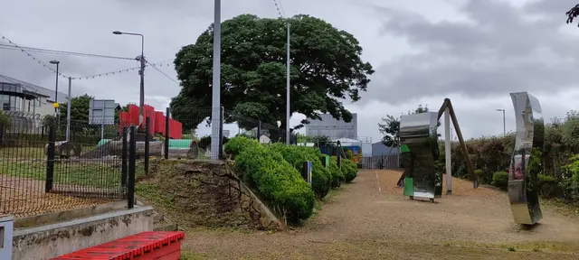 a garden with a fence and trees